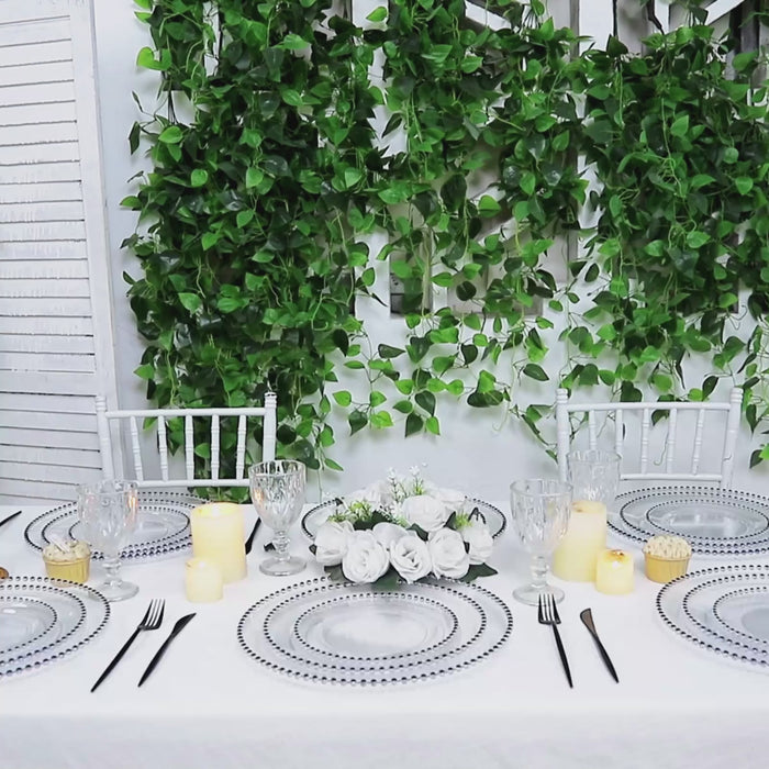 Clear charger plates with black beaded rim for stylish dining setup.