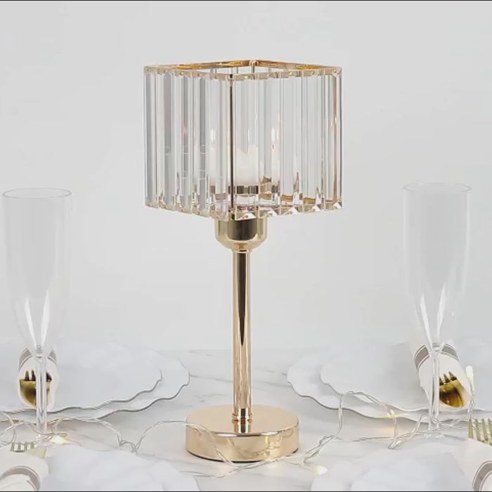 Gold crystal hurricane candle holder on a table setting.