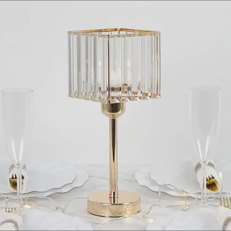Gold crystal hurricane candle holder on a table setting.