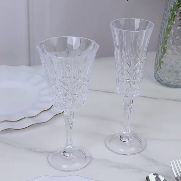 Clear shatterproof plastic champagne flutes with embossed leaf pattern.