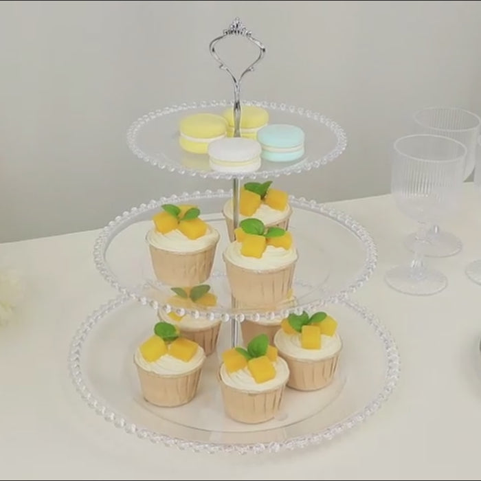 Clear 3-tier round plastic cupcake tower stand with desserts on display.