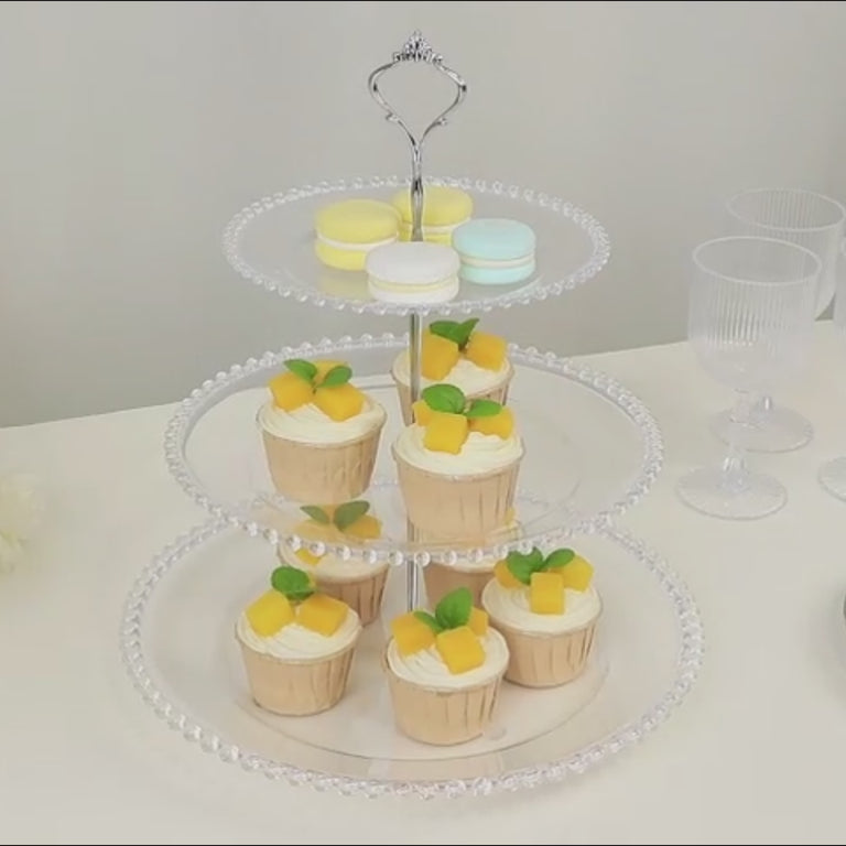 Clear 3-tier round plastic cupcake tower stand with desserts on display.