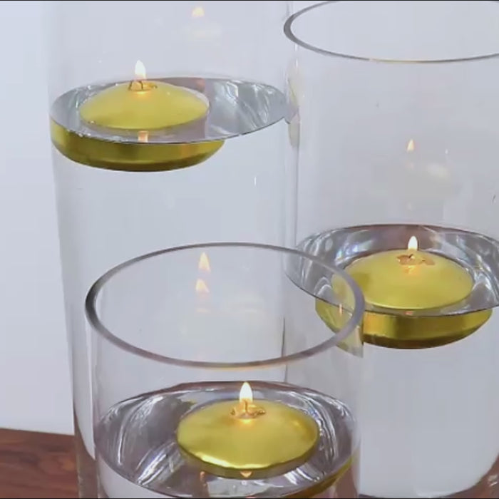 Gold floating candles in clear vases, perfect for centerpieces.