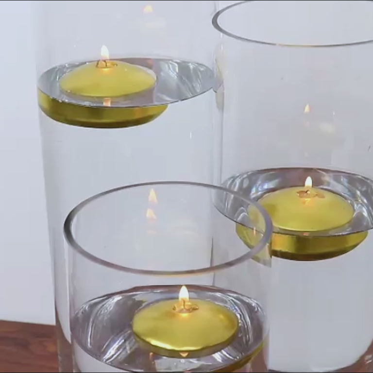 Gold floating candles in clear vases, perfect for centerpieces.