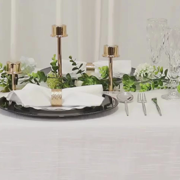 Navy blue beaded rim charger plates on an elegant dining table setting.