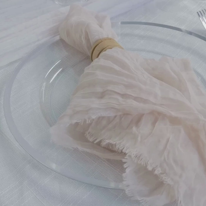 Cream gauze napkin wrapped on a plate, perfect for boho dinner settings.