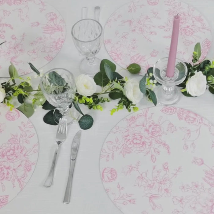 White and matte pink disposable placemats in French toile print for elegant dining.