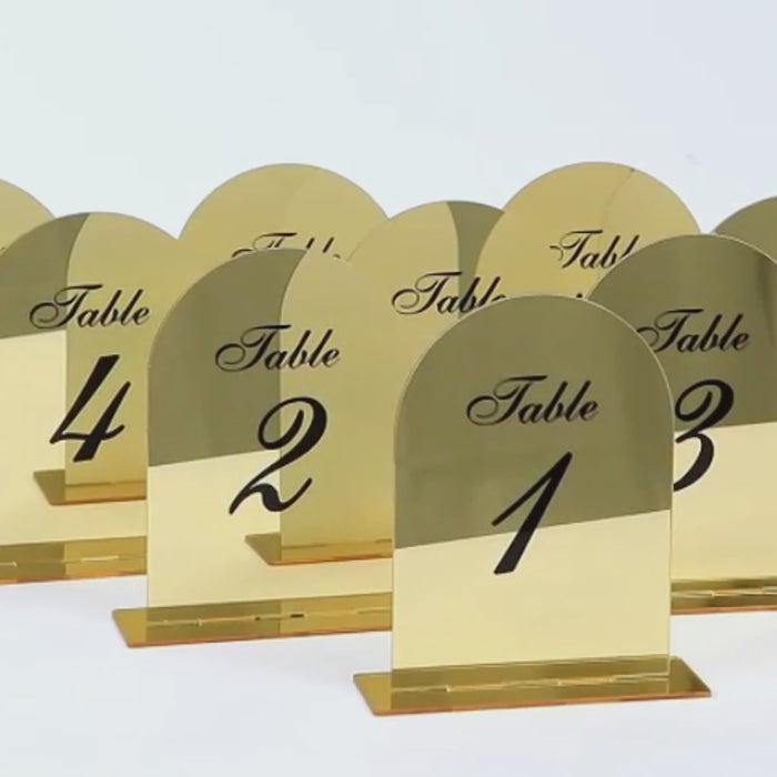Gold mirror table numbers 1-10 with black print for elegant receptions.