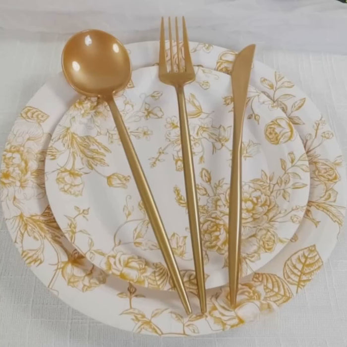 Gold heavy duty plastic utensil set on floral plates.