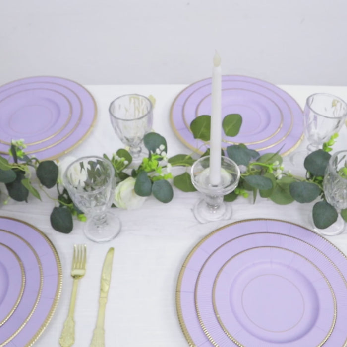 Lavender lilac round charger plates with gold rim on a table setting.