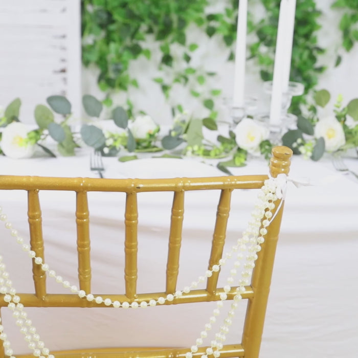Gold faux pearl beaded chair back garland for Chiavari chairs.