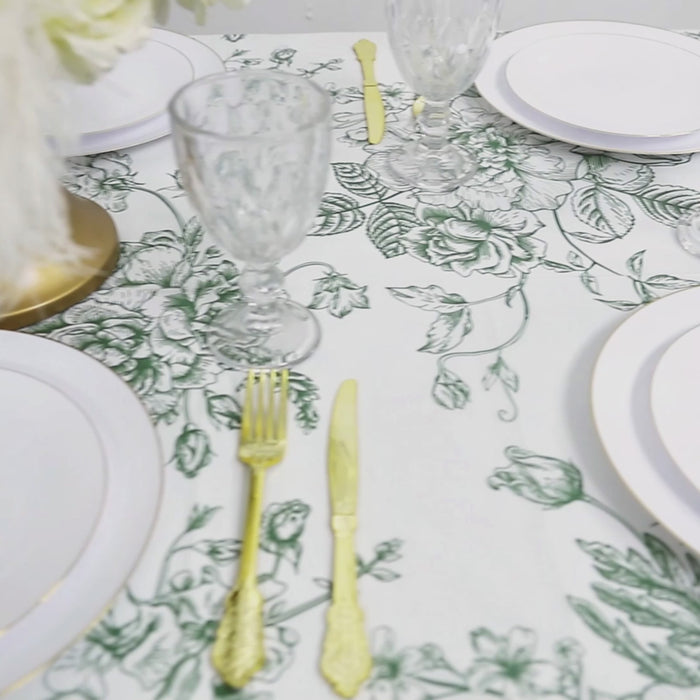 White tablecloth with sage green French toile pattern, perfect for dining.
