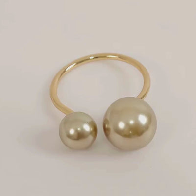 Champagne pearl metal napkin rings for elegant dining table decor.