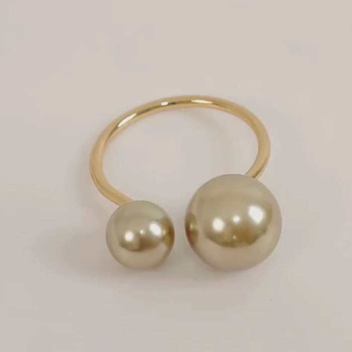 Champagne pearl metal napkin rings for elegant dining table decor.
