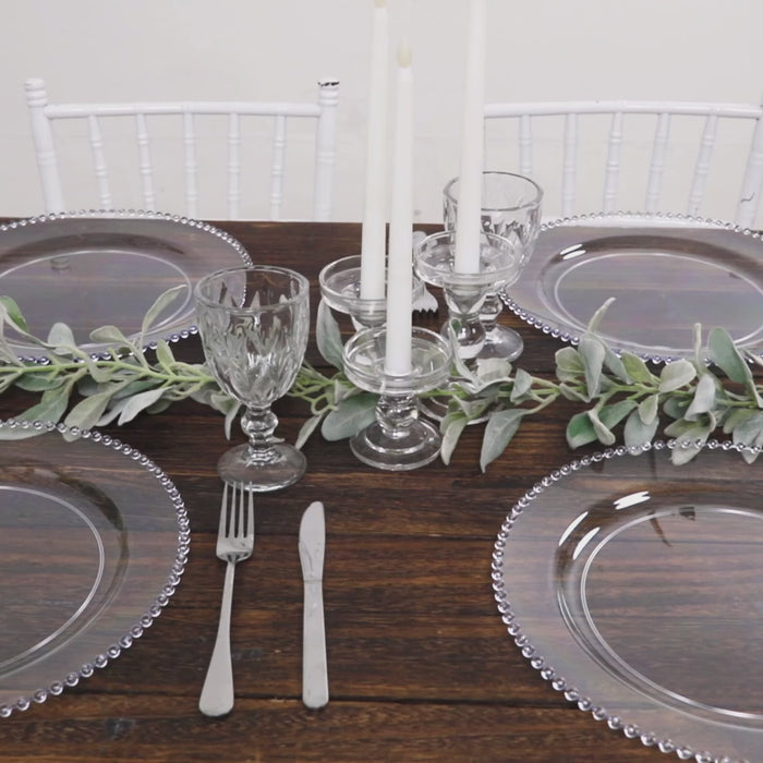 Clear beaded rim charger plates on a stylish dinner table setting.