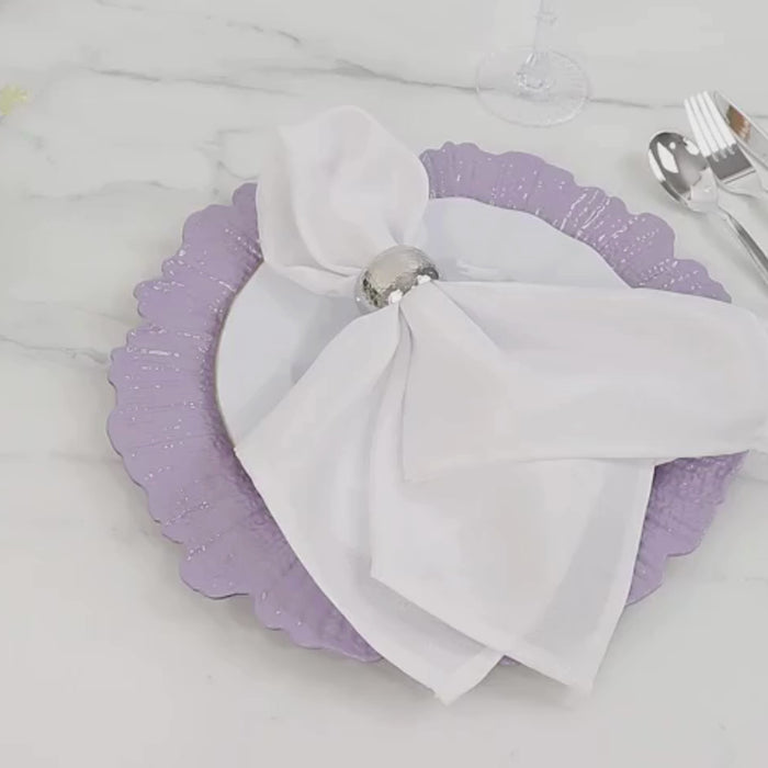 Lavender lilac charger plate with decorative reef design on a table setting.