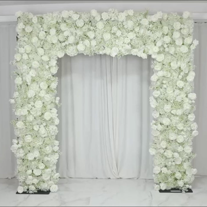 White artificial flower backdrop with silk roses and baby's breath for wedding arch.