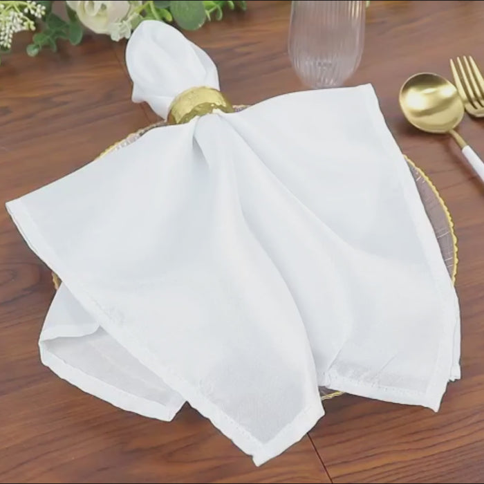 Clear plastic dessert plate with gold rim, featuring a white napkin.