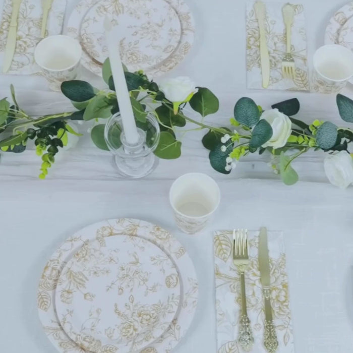 White paper dessert plates with gold floral pattern for elegant table setting.