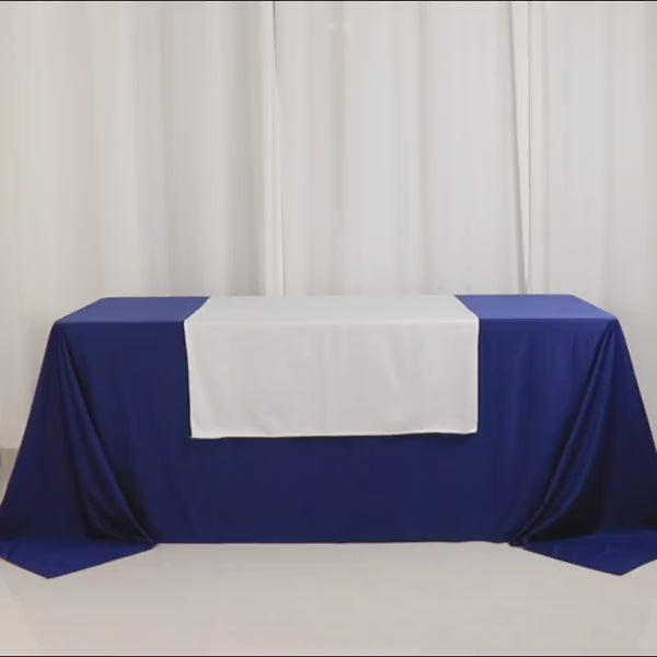 White Scuba Polyester Wide Table Runner on blue table for events and exhibits.