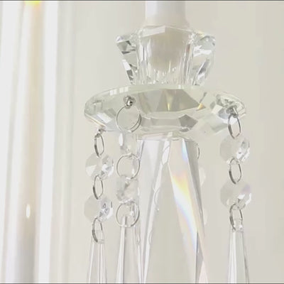 Clear crystal candelabra with hanging accents and hurricane glass shades.