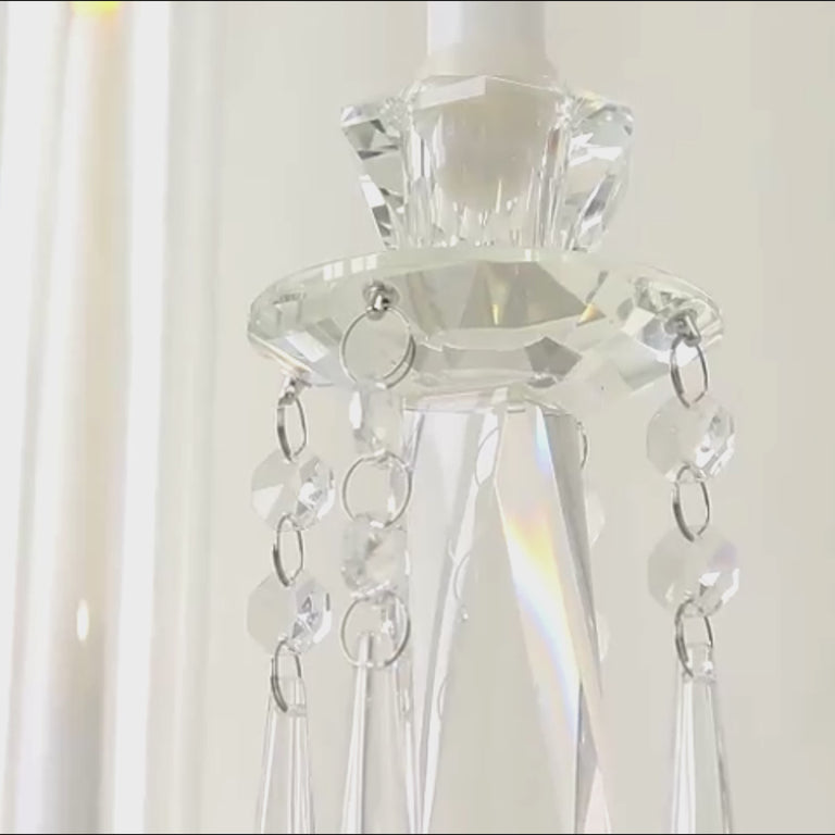Clear crystal candelabra with hanging accents and hurricane glass shades.