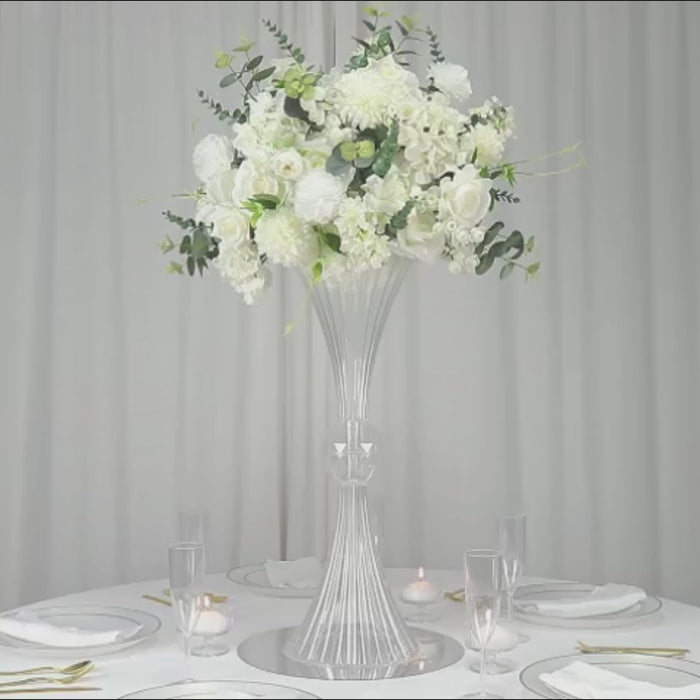 Clear ribbed acrylic trumpet vase with crystal ball accent and white flower arrangement.
