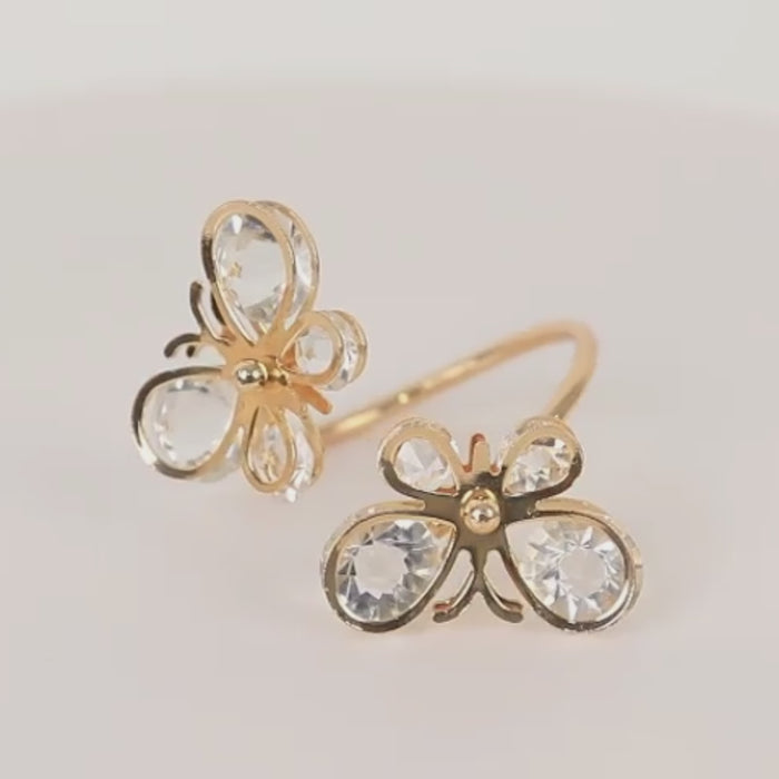 Gold butterfly napkin rings with crystal accents for weddings and events.