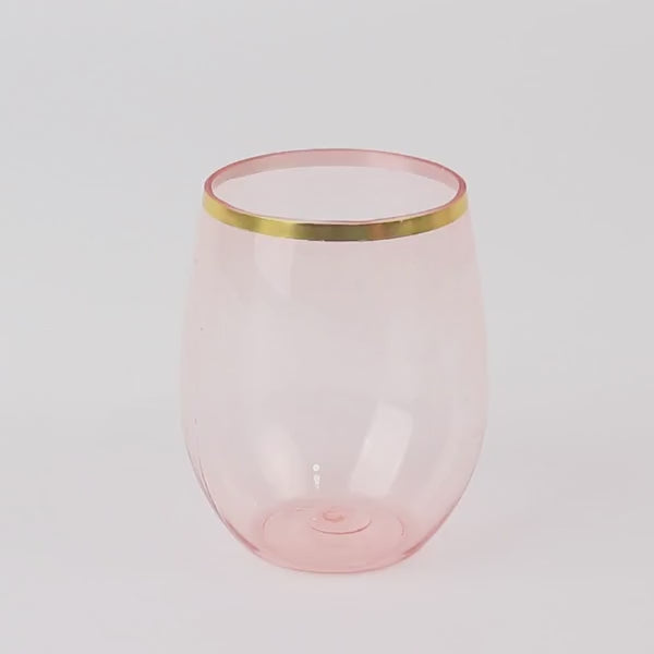 Transparent blush stemless wine glass with gold rim.