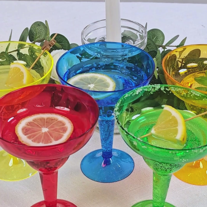 Assorted color plastic margarita glasses with lemon slices for parties.