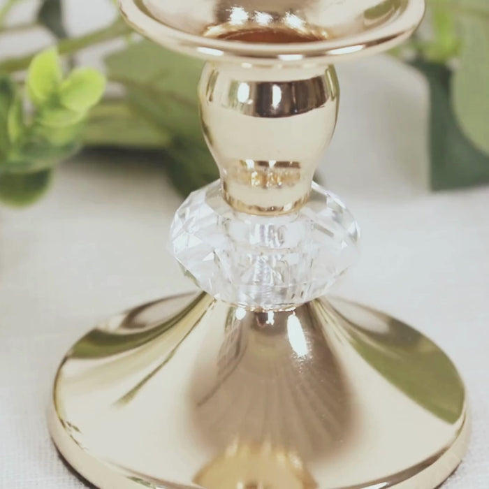 Gold metal taper candle holder with crystal ball detail.