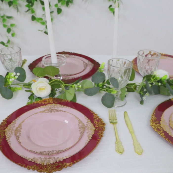 Burgundy charger plates with gold embossed rim set for a stylish dinner party.