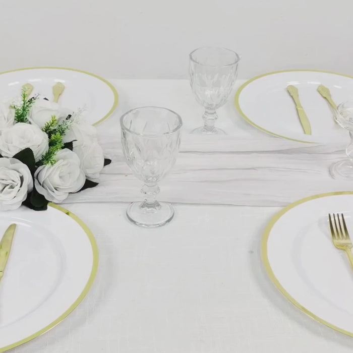 White charger plates with wide gold rim, perfect for dinner parties.