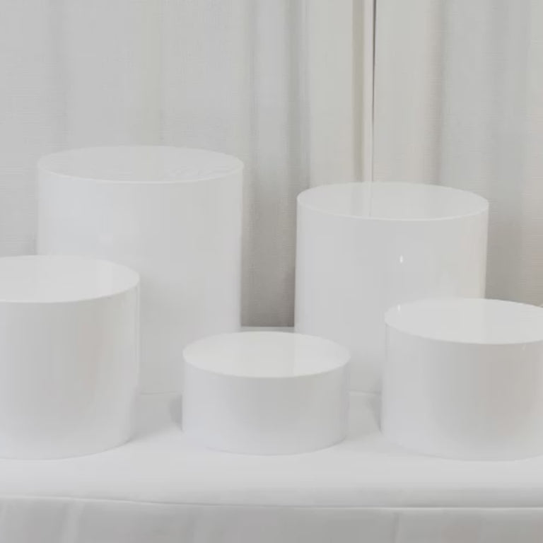 White acrylic cake stands in a round cylinder design, set of 5.