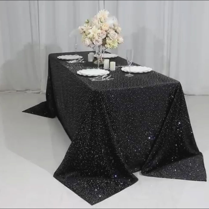 Black tablecloth with rhinestone accents for elegant events.