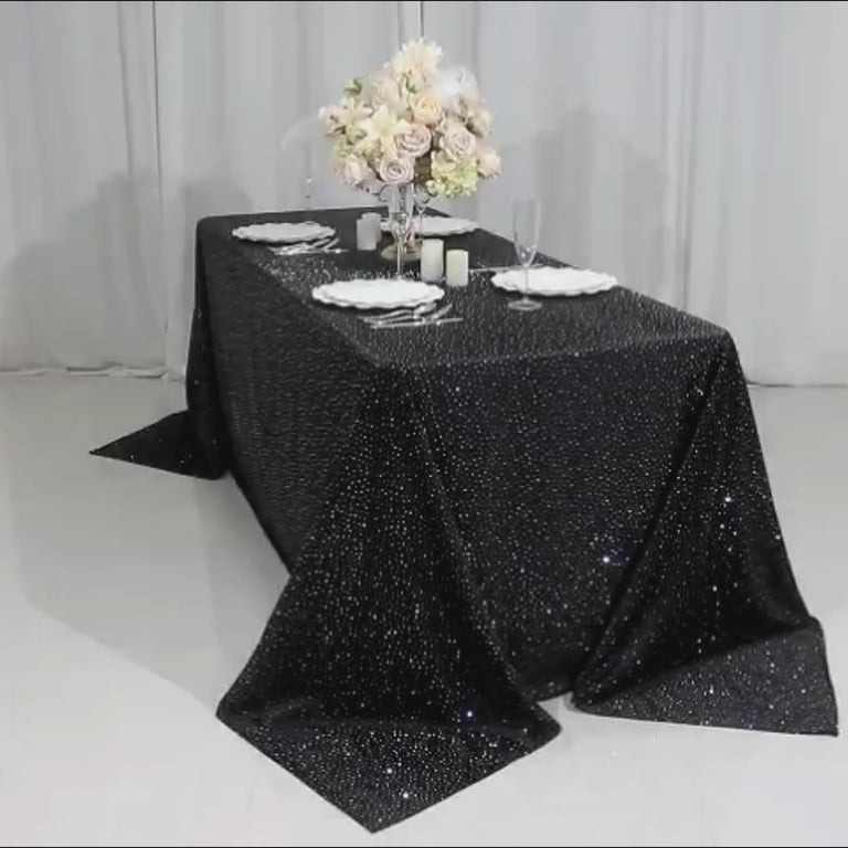 Black tablecloth with rhinestone accents for elegant events.