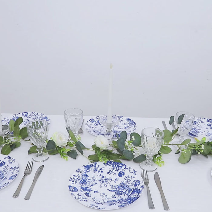 Blue & white floral disposable plates arranged on a table setting.