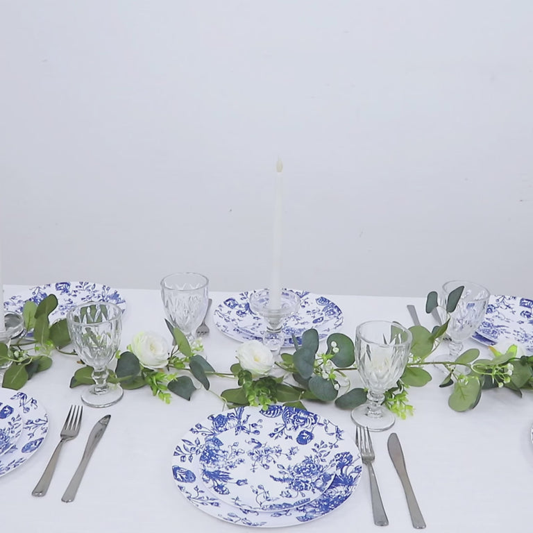 Blue & white floral disposable plates arranged on a table setting.