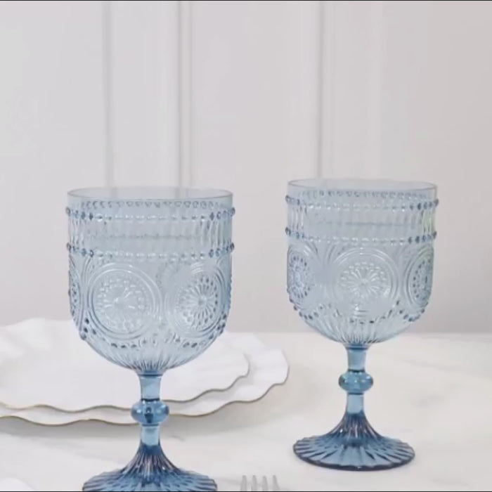 Dusty blue vintage wine goblets with embossed floral pattern.