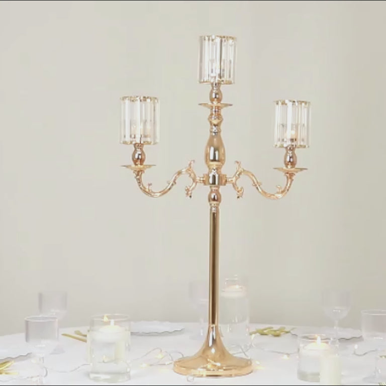 Gold metal candelabra with crystal shades, 34" tall, perfect for candles.
