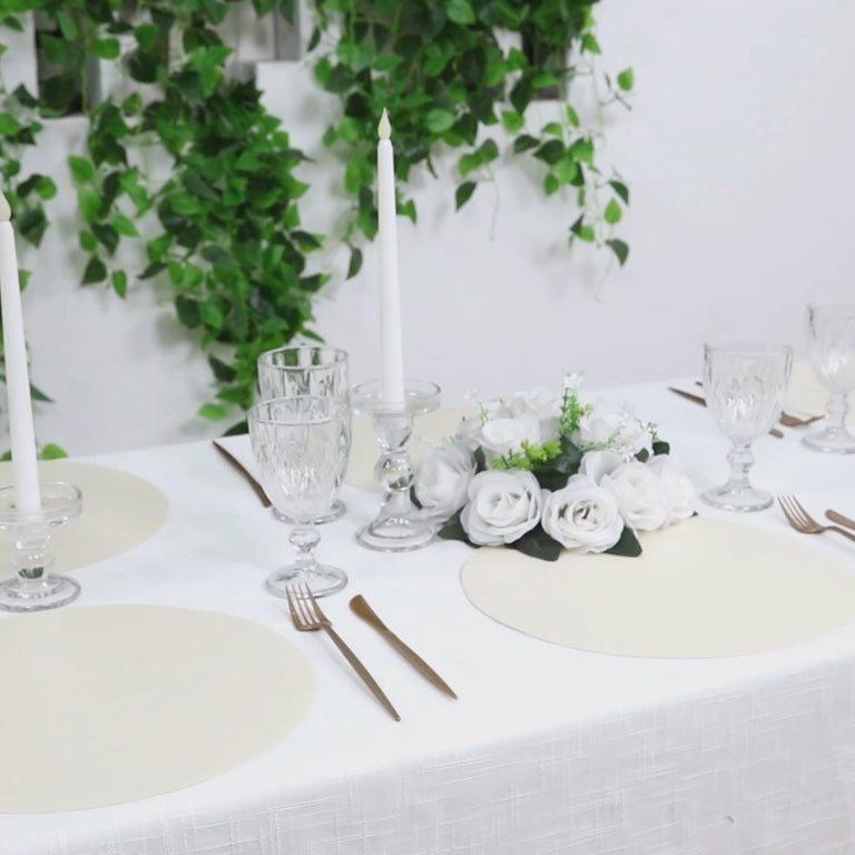 Pearl white disposable paper placemats on a dining table setting.