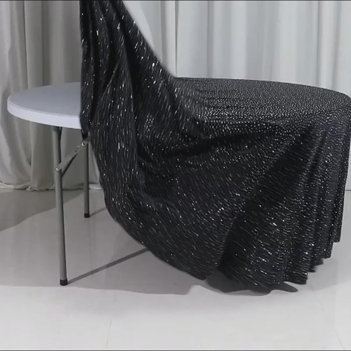 132″ black tablecloth with rhinestone accents on a round table.