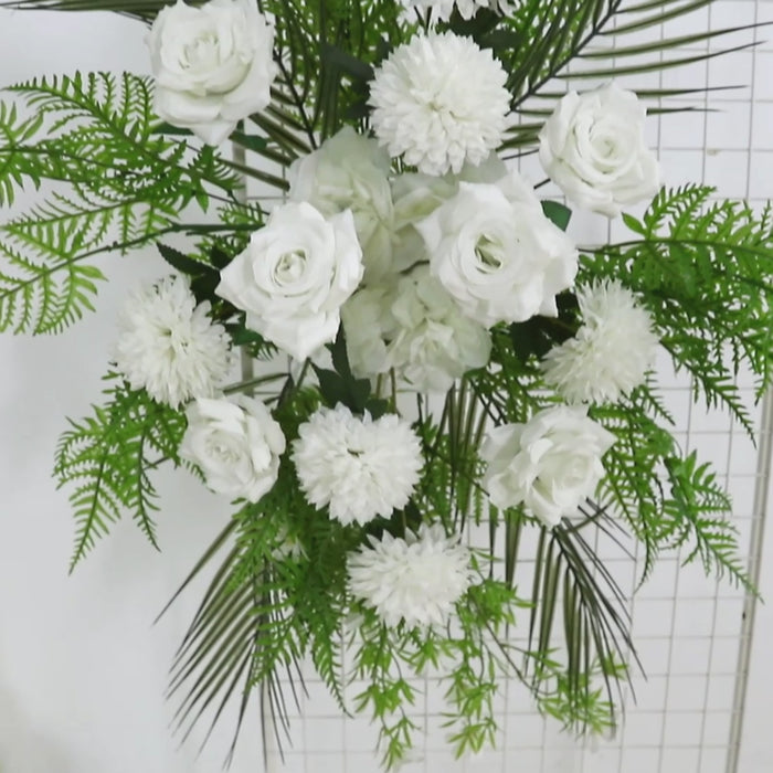 Ivory rose and chrysanthemum floral swag with greenery and palm leaves.
