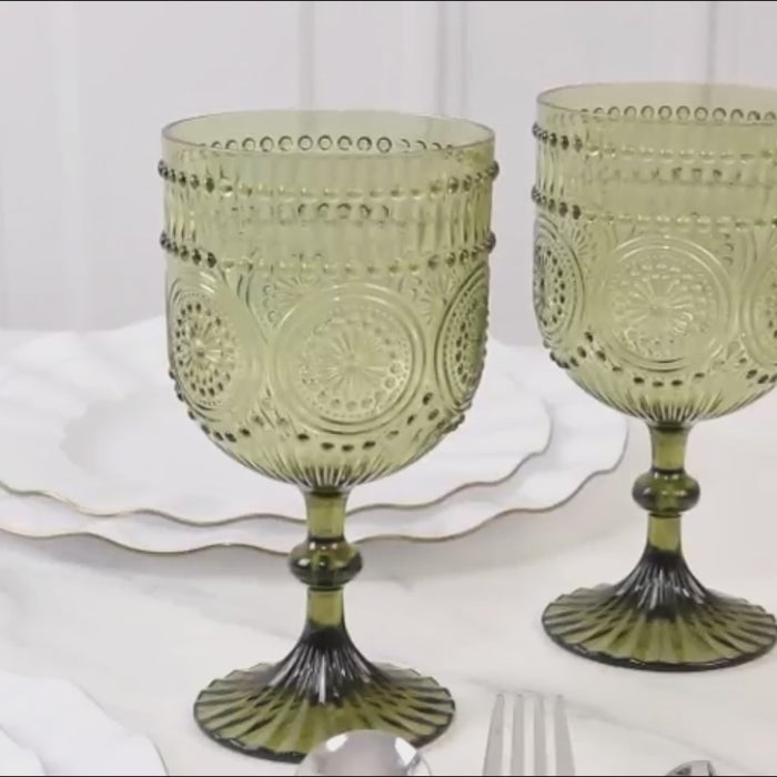 Dusty sage green embossed floral wine goblets on a table setting.