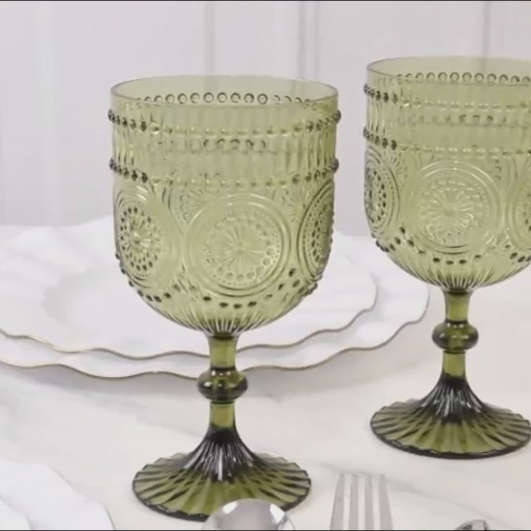Dusty sage green embossed floral wine goblets on a table setting.