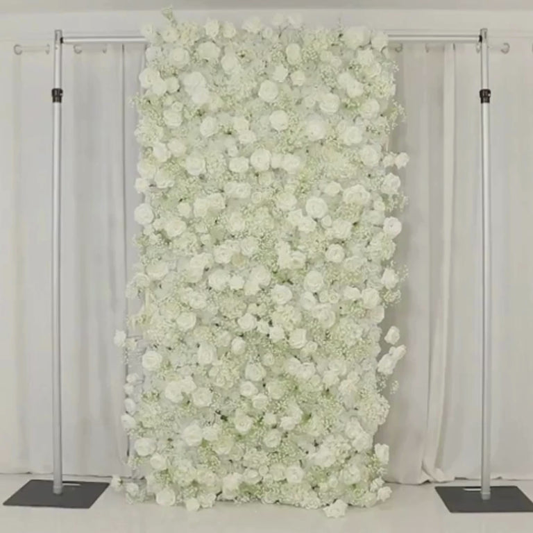 White roll-up flower wall backdrop with artificial silk roses and baby's breath.