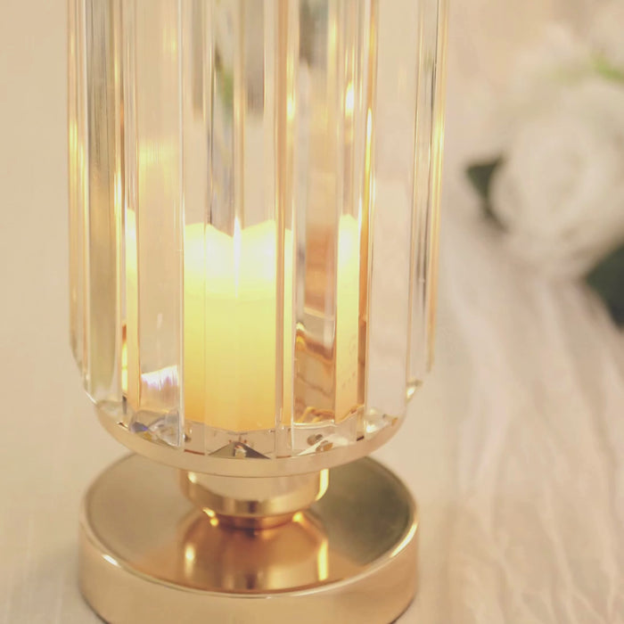 Gold crystal pendant hurricane candle holder with candle inside.