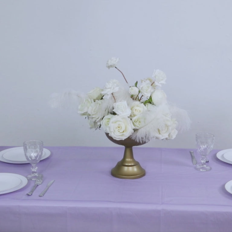 Lavender table cover with elegant floral arrangement on a table setting.