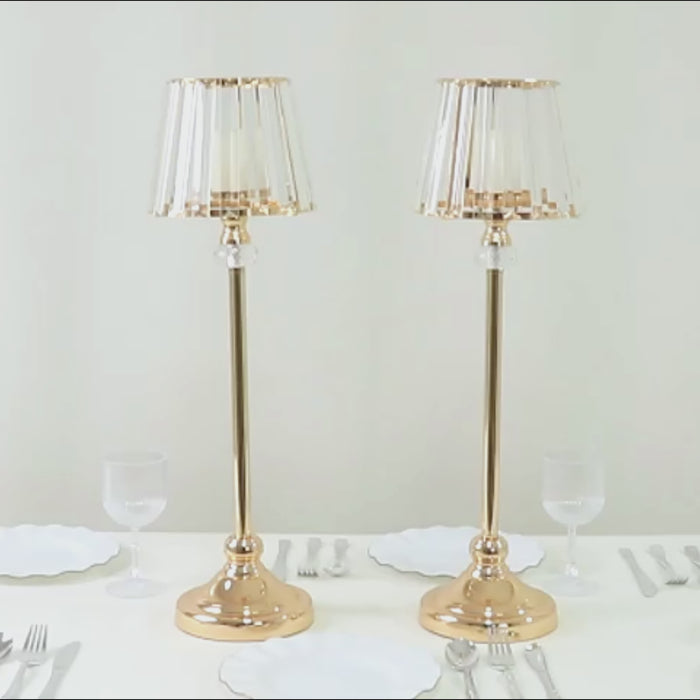 Gold crystal pendant candle holders with classic empire lamp shade style.