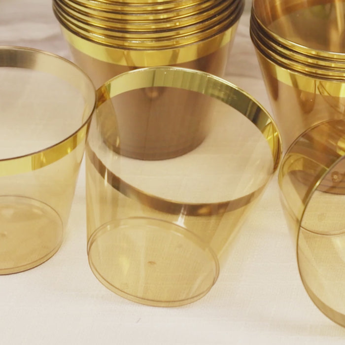 Amber gold plastic party cups with a gold rim, perfect for celebrations.